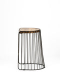 Black wire stool with wooden top on a white background
