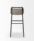 Bar stool with gray cushioned seat and black metal frame on a white background