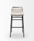 Bar stool with beige seat and black metal legs on a white background