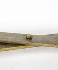 Wooden paddle with a metal button on a white background