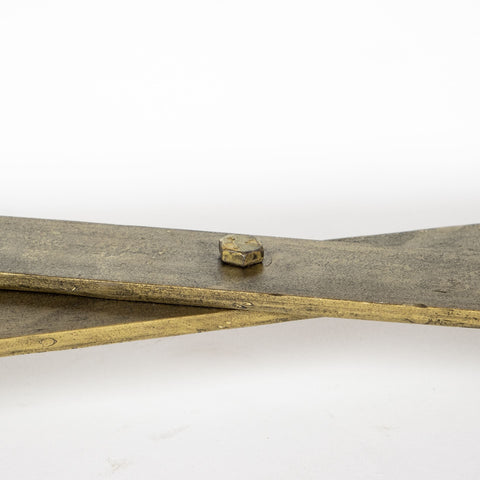 Wooden paddle with a metal button on a white background