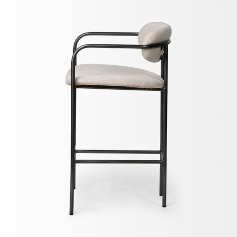 Bar stool with black metal frame and light gray cushioned seat on a white background