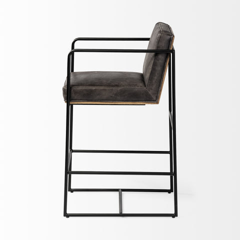 Bar stool with black metal frame and gray cushioned seat on a white background