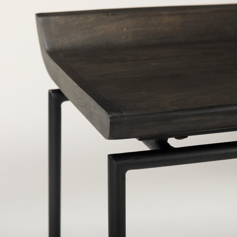 Dark wooden table with black metal legs on a light gray background
