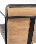 Close-up of a wooden chair with black metal frame and gray cushion.