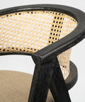 Chair with black frame and woven backrest on a white background