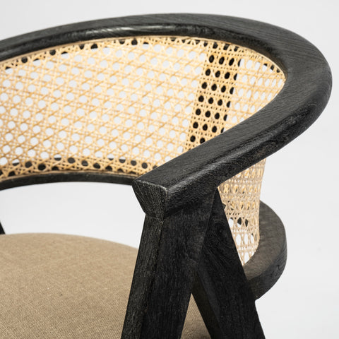 Chair with black frame and woven backrest on a white background