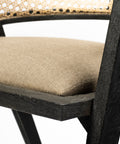 Chair with woven backrest and brown cushion on a white background
