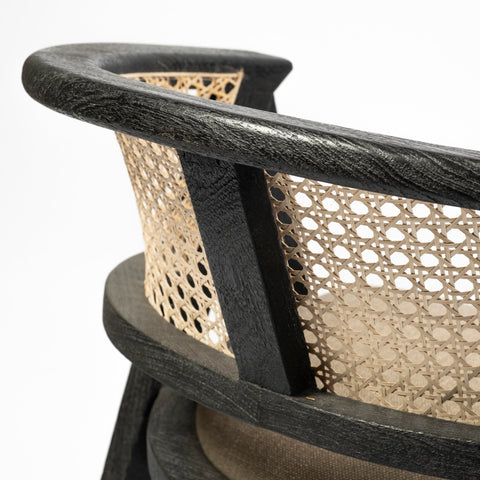 Close-up of a chair with black frame and woven backrest on a white background