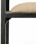 Close-up of a chair with a wooden frame and beige cushion on a white background