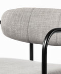 Gray upholstered chair with black metal frame on a white background
