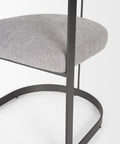Gray cushioned chair with black metal frame on a white background
