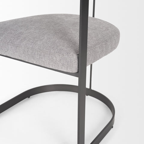 Gray cushioned chair with black metal frame on a white background