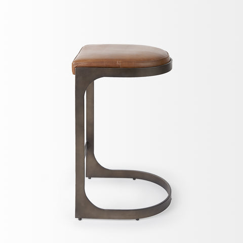 Bar stool with brown leather seat and metal frame on a white background