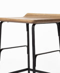 Wooden bar stool with black metal legs on a white background