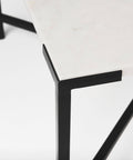 Close-up of a black metal chair leg on a white background