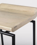 Wooden stool with black metal legs on a light gray background