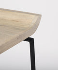 Close-up of a wooden table with a black metal leg on a white background