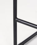 Close-up of a black metal frame on a white background