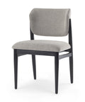 Gray upholstered chair with black frame on a white background