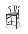 Black bar stool with beige cushion on a white background