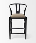 Black bar stool with beige cushion on a white background