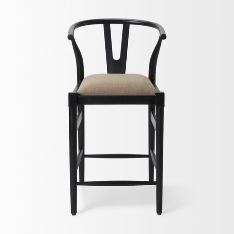 Black bar stool with beige cushion on a white background