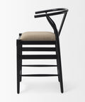 Black bar stool with beige cushion on a white background