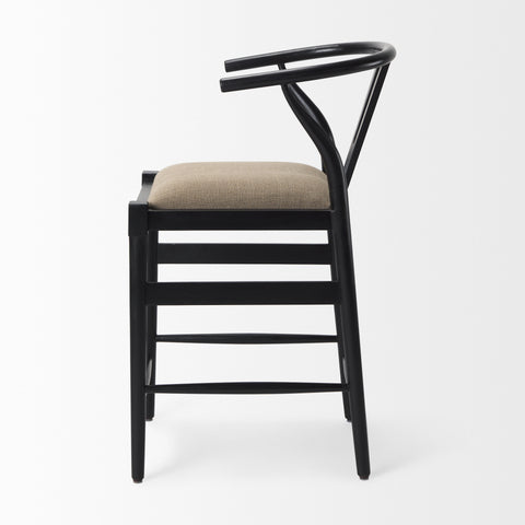 Black bar stool with beige cushion on a white background