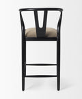 Black bar stool with beige cushion on a white background