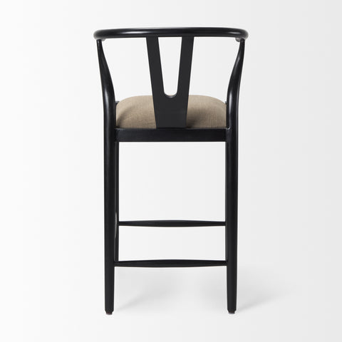 Black bar stool with beige cushion on a white background