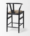 Black bar stool with beige cushion on a white background