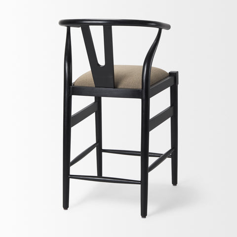 Black bar stool with beige cushion on a white background