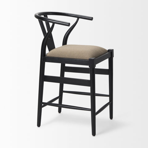 Black bar stool with a beige cushion on a white background