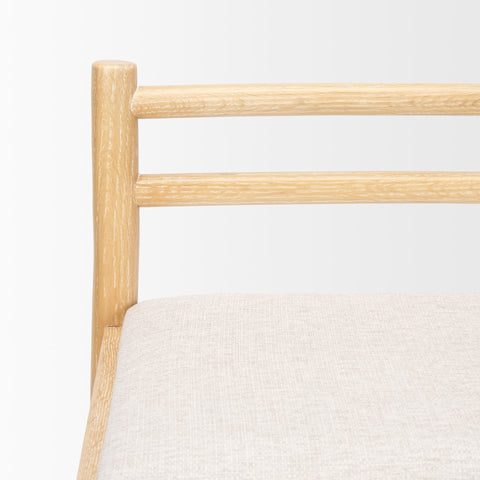 Close-up of a wooden chair with a white cushion on a light gray background