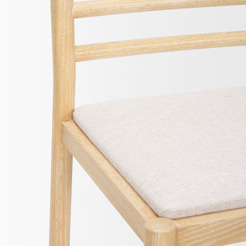 Wooden chair with a white cushion on a white background