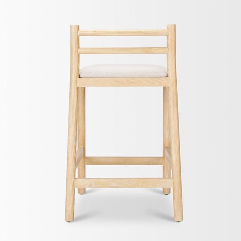 Wooden bar stool with a white cushion on a light gray background