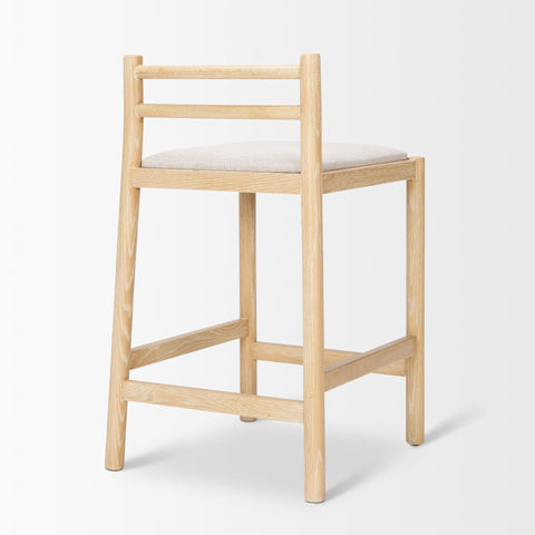 Wooden bar stool with a white cushion on a light gray background