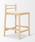 Wooden bar stool with a white cushion on a light gray background