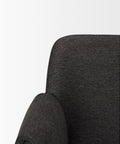 Close-up of a dark gray upholstered chair on a white background