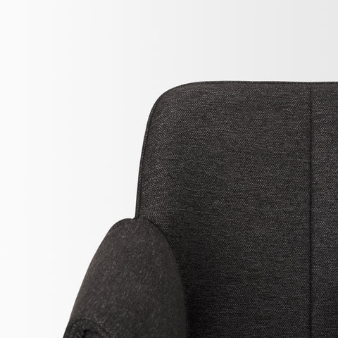 Close-up of a dark gray upholstered chair on a white background