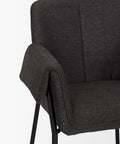 Dark gray upholstered chair with armrest on a white background