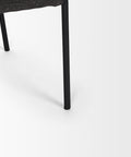 Close-up of a black chair leg on a white background