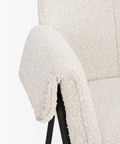 Close-up of a textured white chair with a black base on a white background