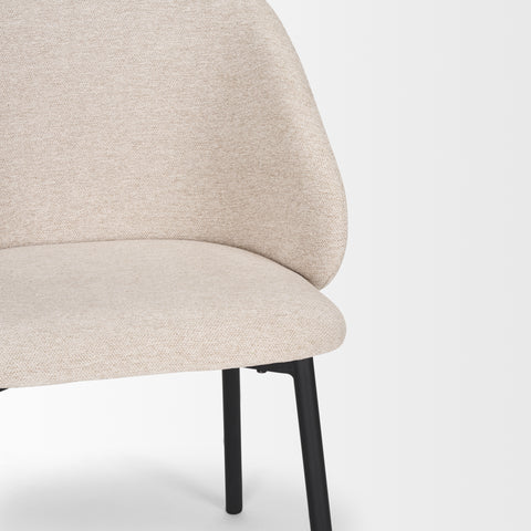 Beige chair with black legs on a white background