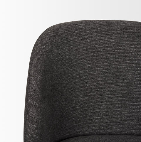 Close-up of a dark gray upholstered chair on a white background