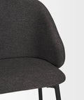 Dark gray upholstered chair on a light gray background