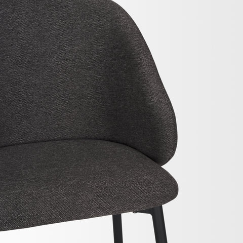 Dark gray upholstered chair on a light gray background