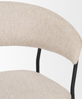 Close-up of a beige upholstered chair with black metal legs on a white background