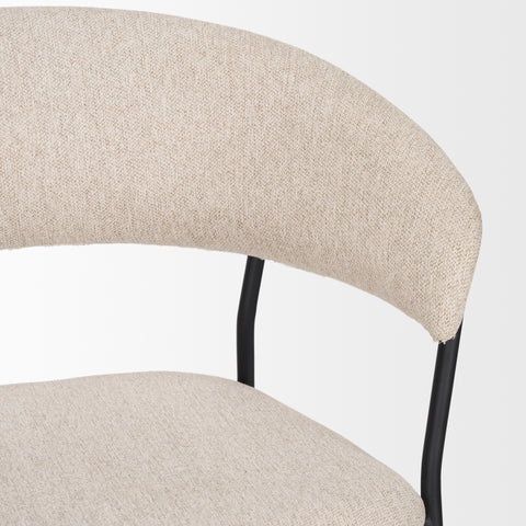 Close-up of a beige upholstered chair with black metal legs on a white background